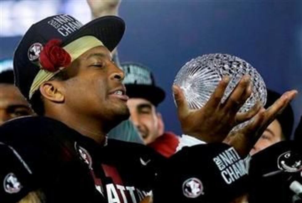 (AP Photo/David J. Phillip). Florida State's Jameis Winston with The Coaches' Trophy after the...