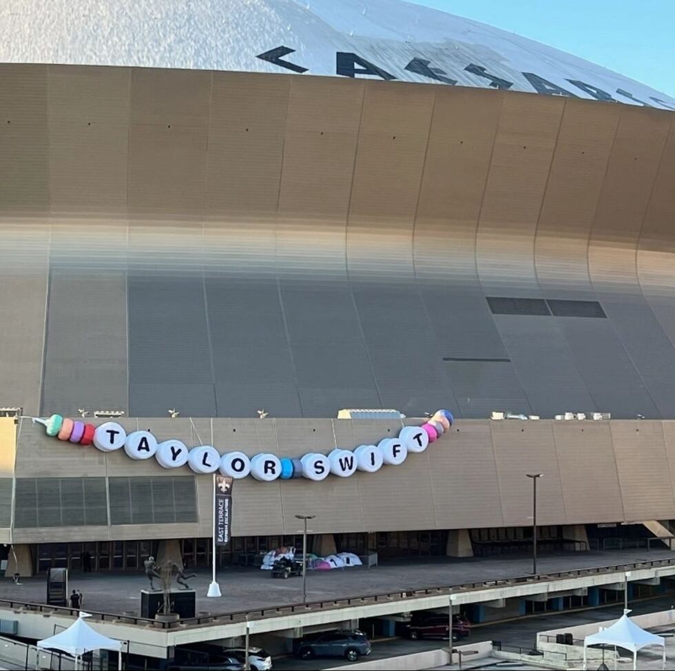 A massive decorative friendship bracelet draped across Caesars Superdome signals the start of...