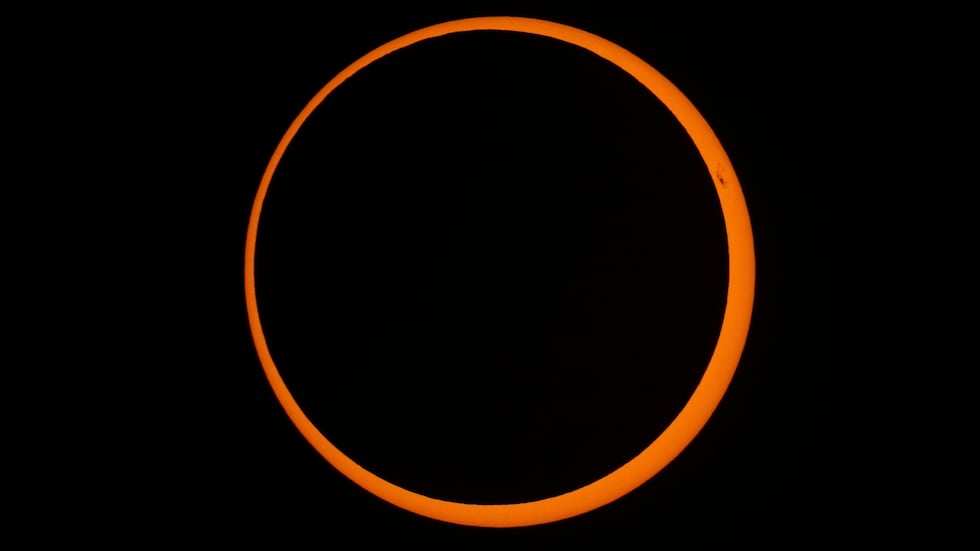 FILE - The moon moves across the sun during a "ring of fire" annular solar eclipse seen from...