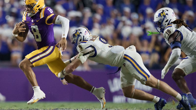 LSU quarterback Husan Longstreet (8) runs against McNeese linebacker Trace Meadows (9) during...