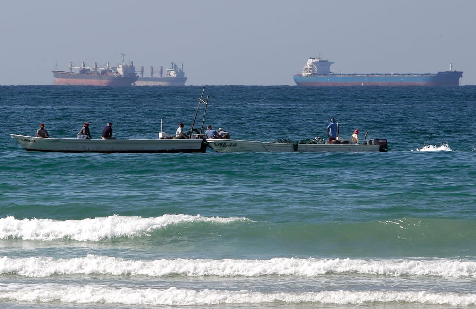 FILE - Fishermen work in front of oil tankers south of the Strait of Hormuz Jan. 19, 2012,...