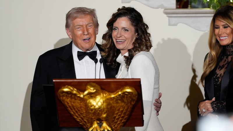 President Donald Trump stands at the podium with Rep. Julia Letlow (R-La.), as he speaks in...