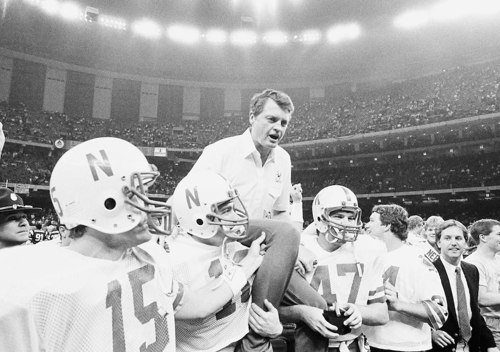 Nebraska coach Tom Osborne is carried off the field by team members after they won the Sugar...