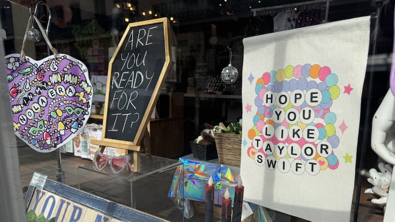 Fleurty Girl decorates window display ahead of Taylor Swift's New Orleans concerts.