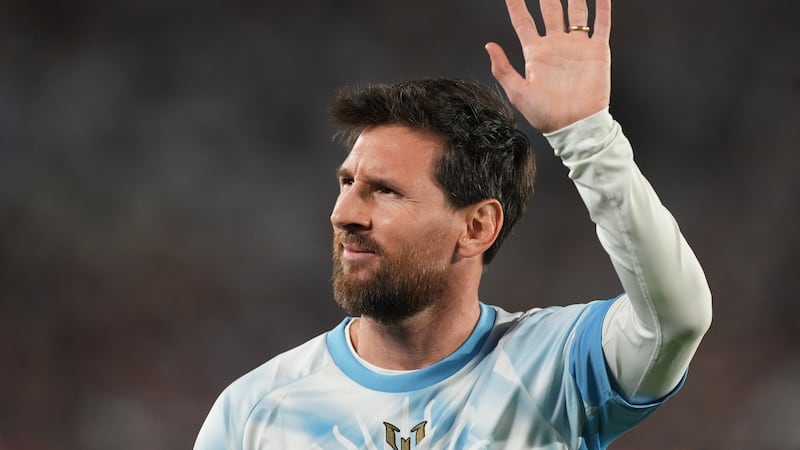 Argentina's Lionel Messi waves to fans before an international friendly soccer match against...