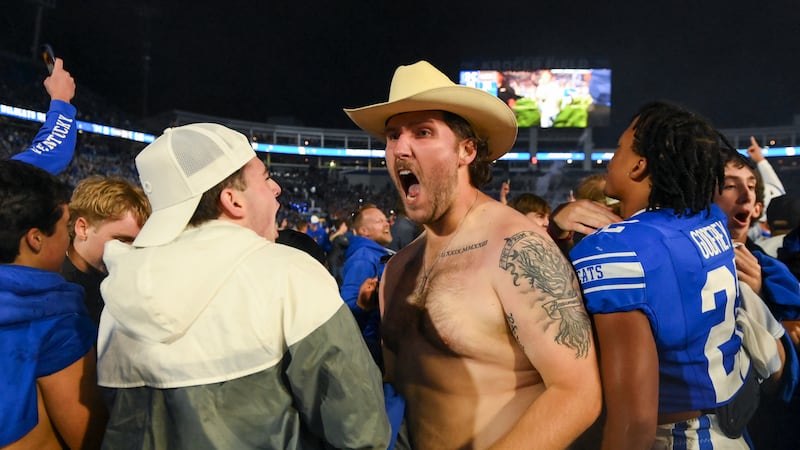 A Kentucky fan celebrates after an overtime win against LSU during an NCCA college football...